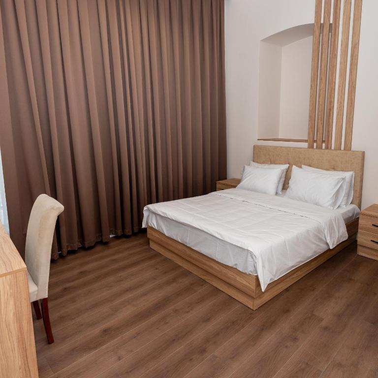 Postel nebo postele na pokoji v ubytování OLF Hotel