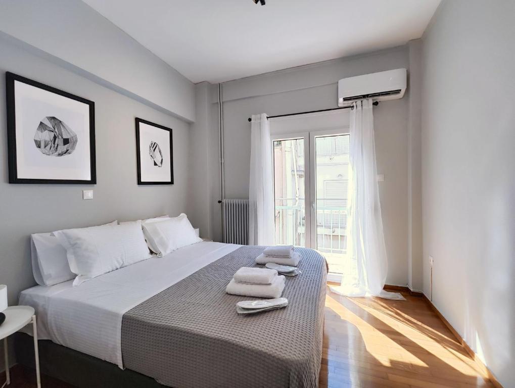 a bedroom with a bed with two towels on it at Zea Apartments in Piraeus