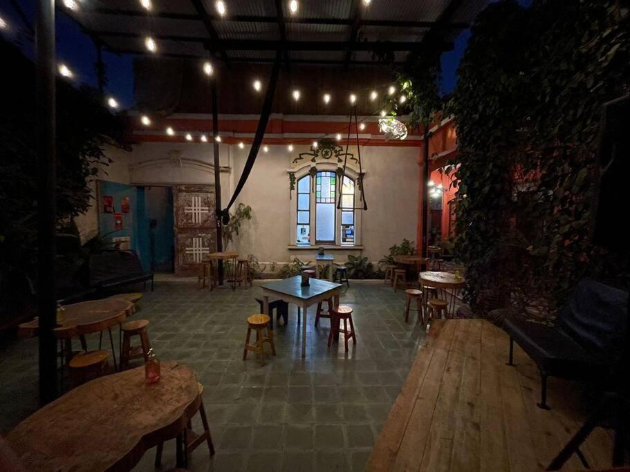 a large room with tables and chairs and lights at Mini Loft 1 en El Circulo in Guatemala
