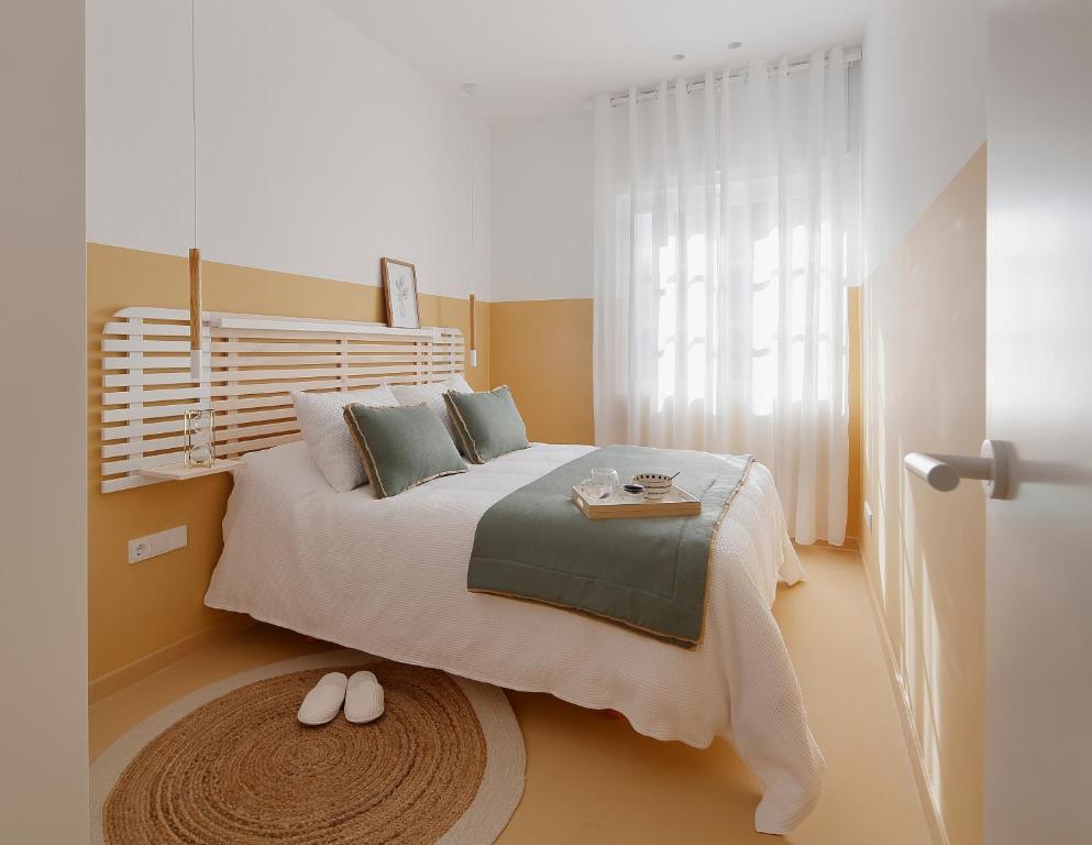 ein Schlafzimmer mit einem großen Bett und einem Tisch darauf in der Unterkunft Apartamento diseño Galiana 6 Avilés Asturias in Avilés