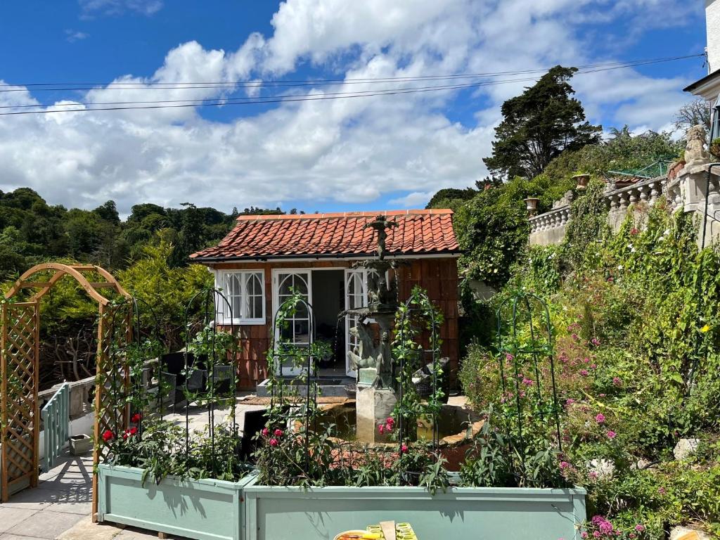 a small house with a garden in front of it at The Little Fountain House in Dawlish