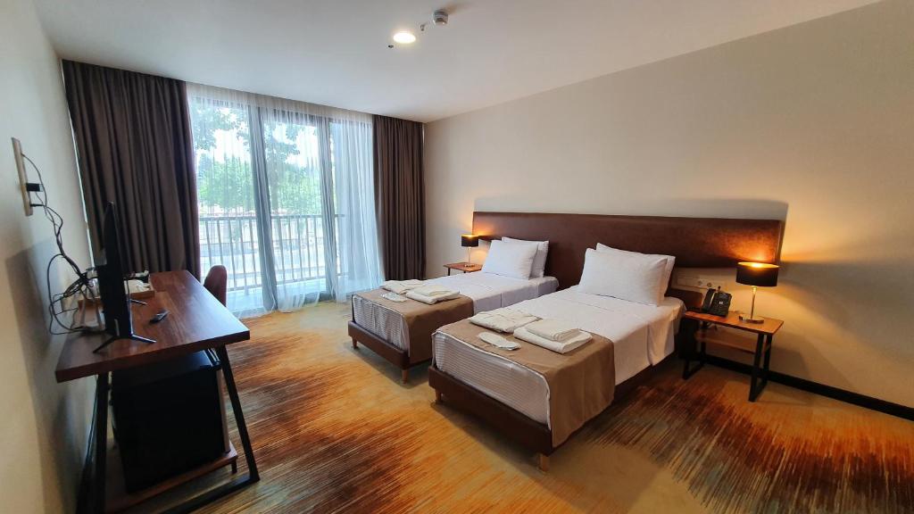 Postel nebo postele na pokoji v ubytování CAROUSEL HOTEL