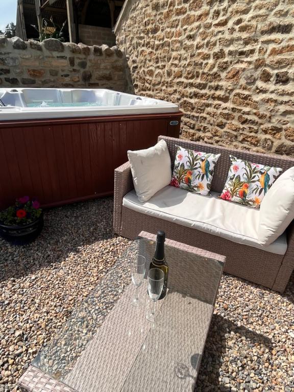 a table with a bottle of wine and two glasses at Barford barn holiday cottage in Darlington