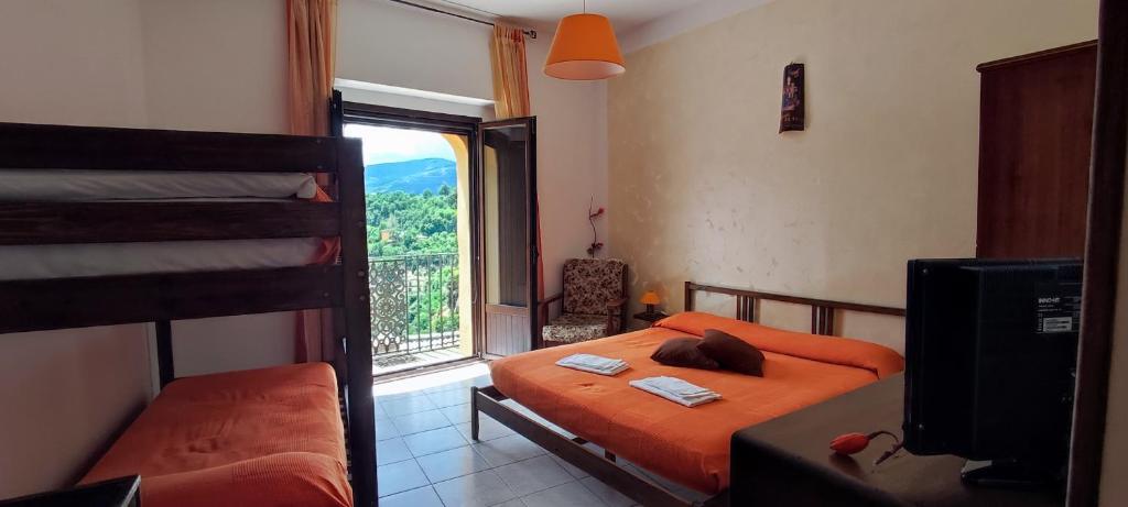 1 dormitorio con 2 literas y ventana en Al Cuore del Borgo, en Castelmezzano