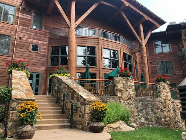 a wooden house with stairs and flowers in front of it at Teton Club in Teton Village