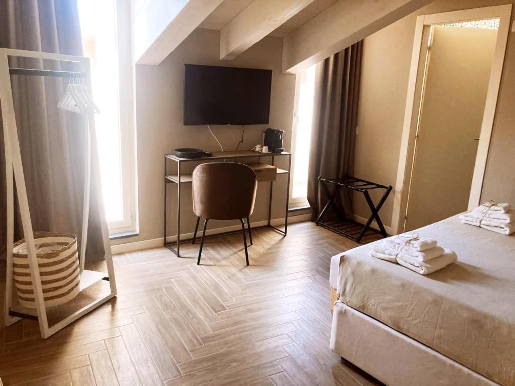 a hotel room with a bed and a desk with a computer at Gatto Bianco Rooms 42 in Bergamo