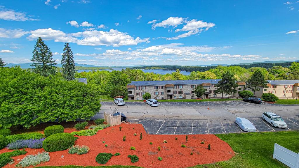 an aerial view of a parking lot with a building at Village of Winnipesaukee in Laconia