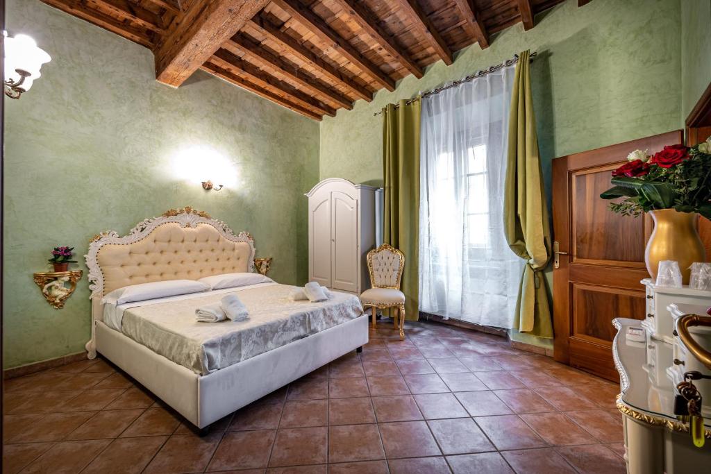 a bedroom with a bed and a chair and a window at Katti House in Florence