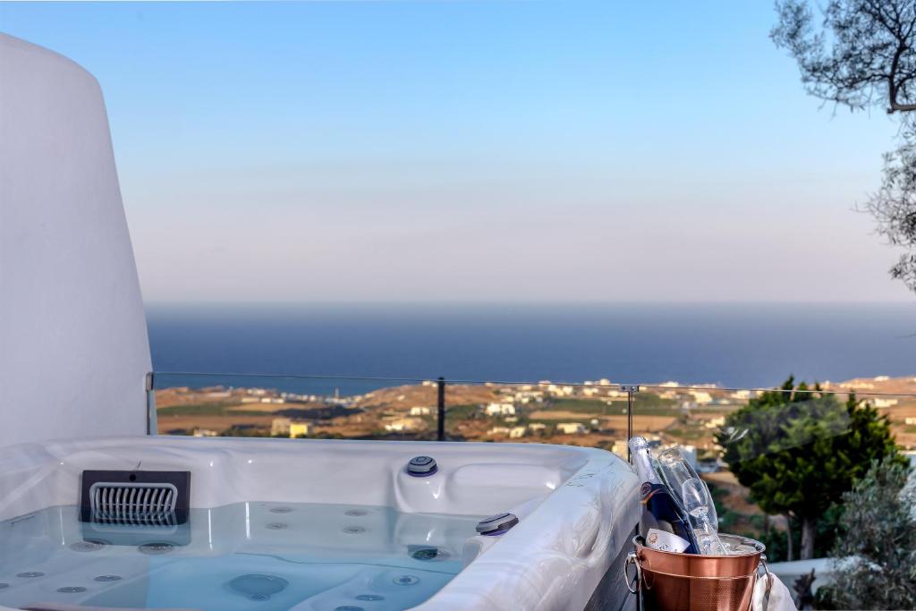 a bath tub with a view of the ocean at Divino Suites in Fira
