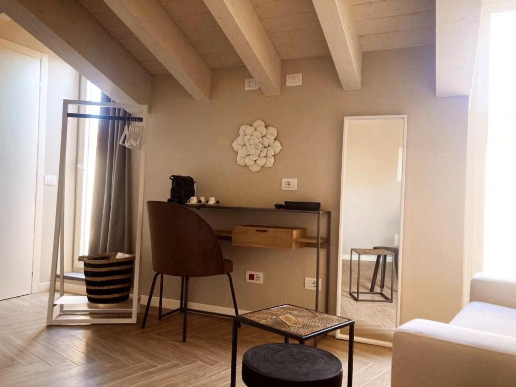 a living room with a table and a couch at Gatto Bianco Rooms 42 in Bergamo