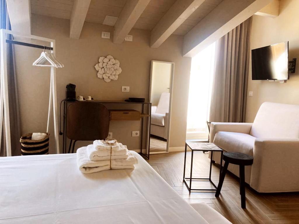 a hotel room with a bed and a living room at Gatto Bianco Rooms 42 in Bergamo