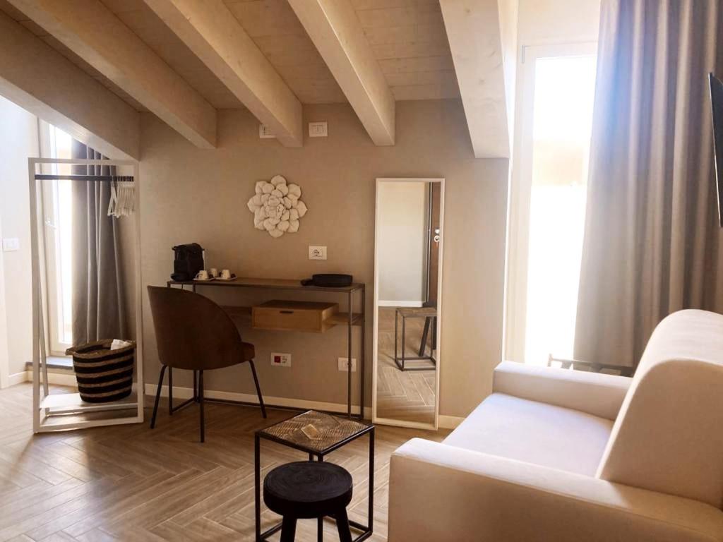 a living room with a couch and a table at Gatto Bianco Rooms 42 in Bergamo