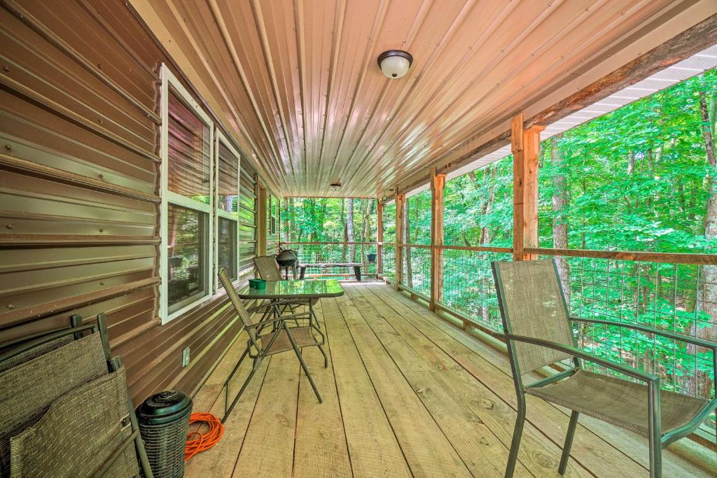 a screened in porch with chairs and a table at Peaceful Decatur Cabin with Grill and Fire Pit! in Decatur