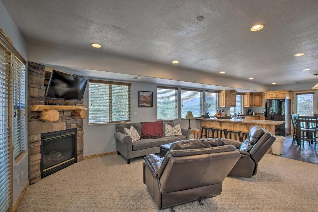 a living room with a couch and a fireplace at Eden Condo Less Than 5 Mi to Nordic Valley Ski Resort in Eden