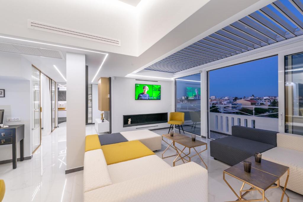 a living room with a couch and a tv at H Experience Spectacular Rooftop Loft in Heraklio
