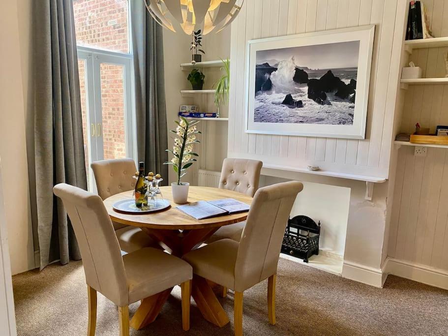 a dining room with a wooden table and chairs at Comfy Home within City Wall, 10 mins Walk to Centre, Attractions & Railway Station in York