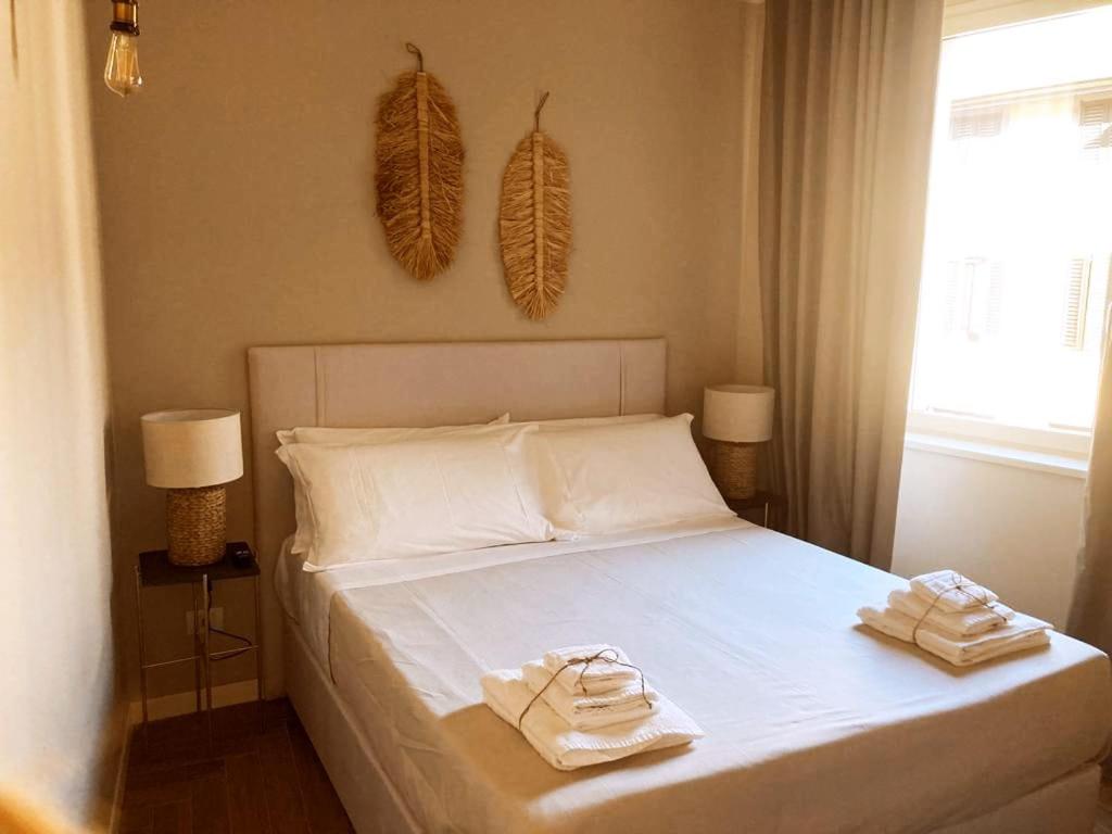 a bedroom with a bed with two towels on it at Gatto Bianco Bergamo Apartment in Bergamo