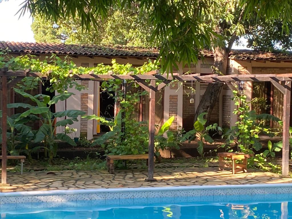 a swimming pool with a pergola next to a house at Hostal Casa Abierta in León
