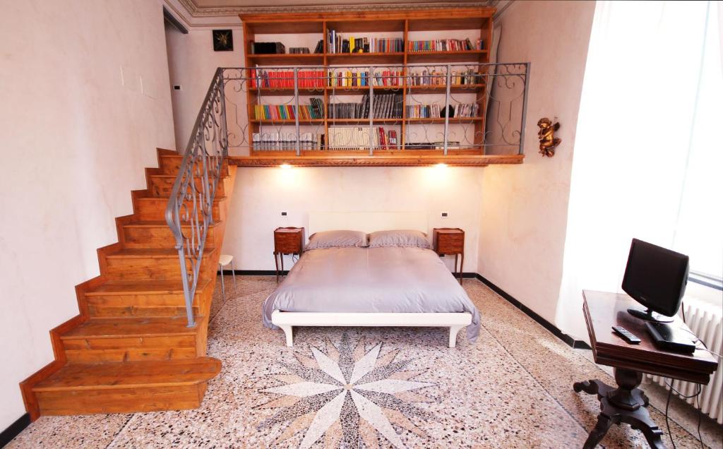 a bedroom with a bed and a stair case at Due Papi in Savona