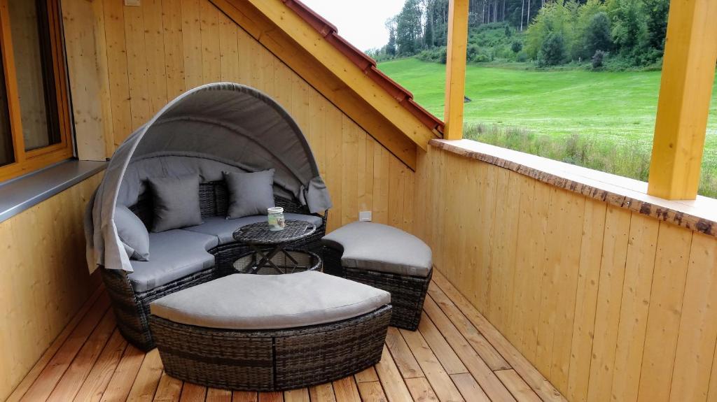 a gazebo with two chairs and a table on a porch at WaldBlick im Happy Allgäu - Wohnung mit großer Dachterrasse in Leutkirch im Allgäu