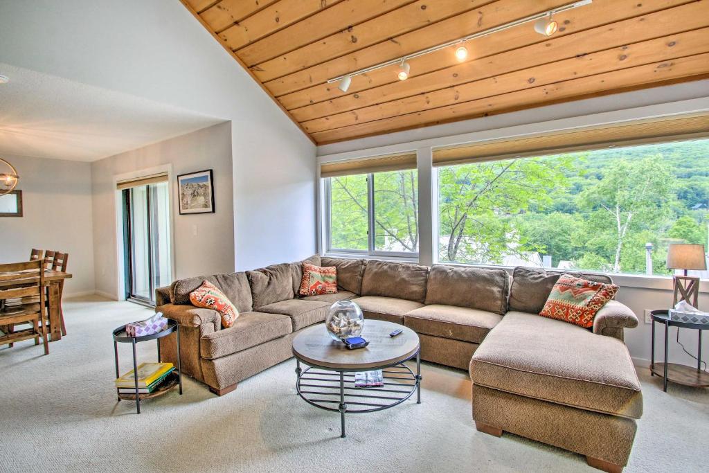 a living room with a couch and a table at Cozy Lincoln Condo about 1 Mi to Loon Mountain! in Lincoln