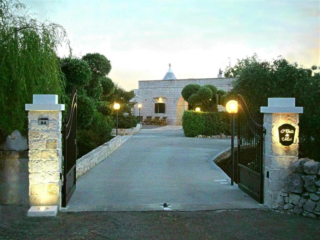 ein Tor zu einem Haus mit Lichtern an einer Einfahrt in der Unterkunft Trulli di Marì in Locorotondo