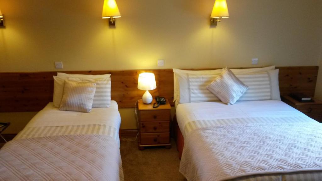 Postel nebo postele na pokoji v ubytování Ballyraine Guesthouse