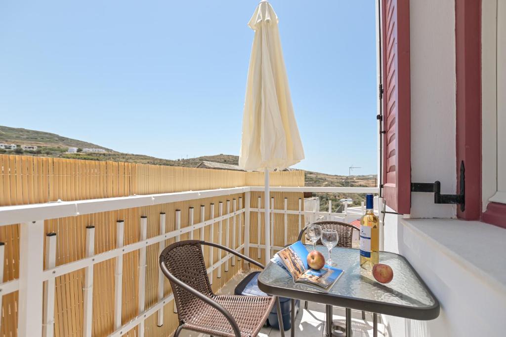 a balcony with a table with a baby on it at Akakia Residence - Vivlos Village in Vívlos