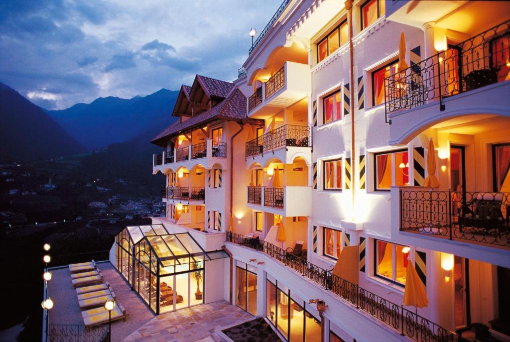 a view of a building at night at Hotel Finkennest - Panoramic Garden Resort in Schenna