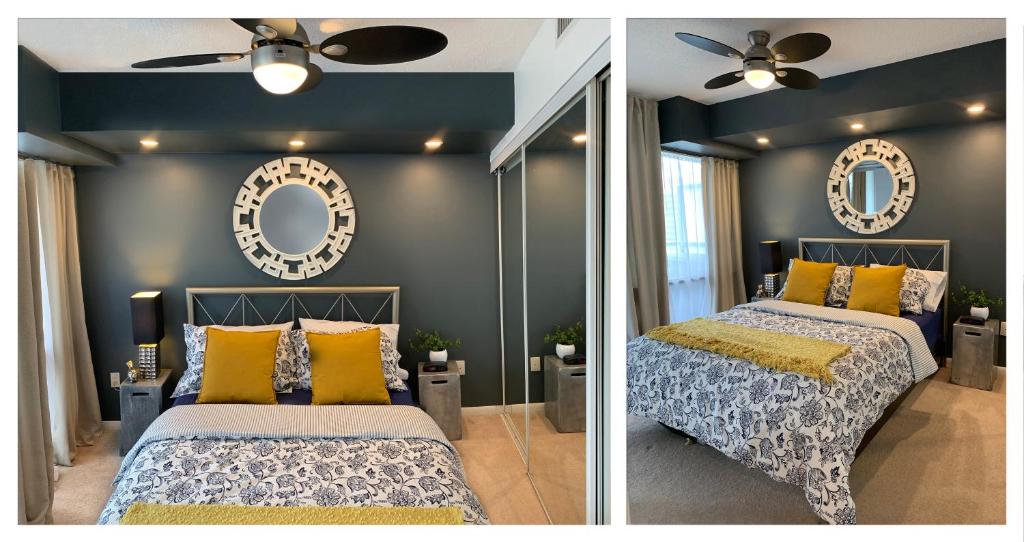 a bedroom with two beds and a mirror at Cozy Condo in Centre of Downtown Toronto in Toronto