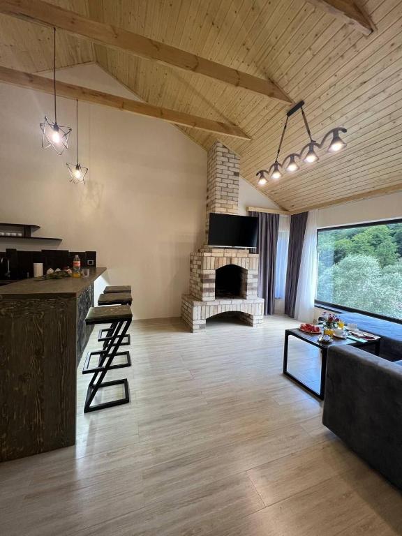 a living room with a couch and a fireplace at Dili guest house in Dilijan