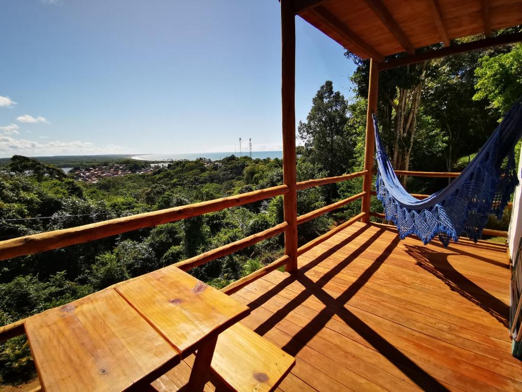 a porch with a bench and a hammock on it at Vila Boa Vista Itacaré in Itacaré