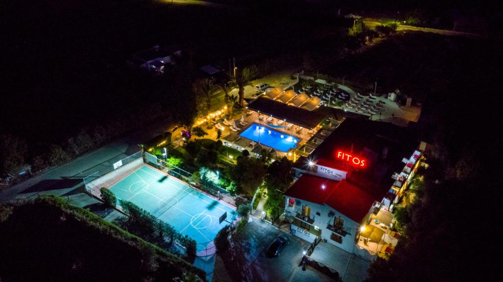 an overhead view of a swimming pool at night at Fitosinn Hotel in Paphos