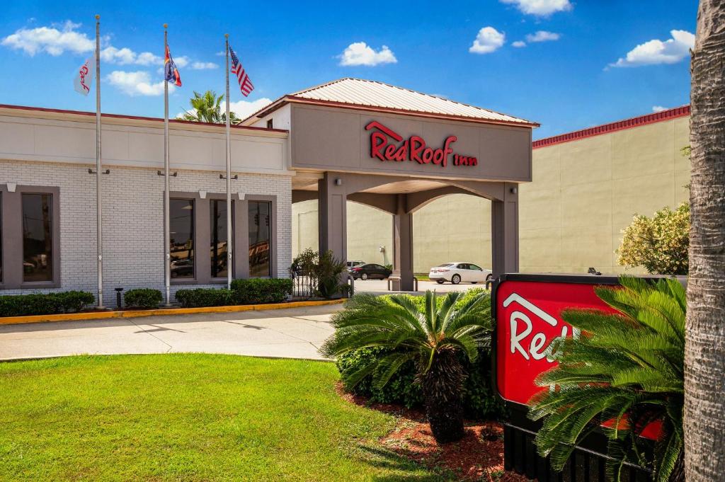 a red coca cola sign in front of a restaurant at Red Roof Inn Gulfport - Biloxi Airport in Gulfport