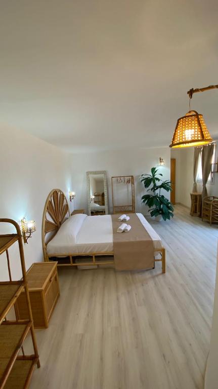 a bedroom with a large bed and a mirror at Greek Temple in Agrigento