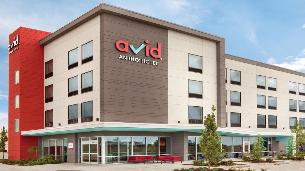 an office building with a sign on it at avid hotels - Round Rock South, an IHG Hotel in Round Rock