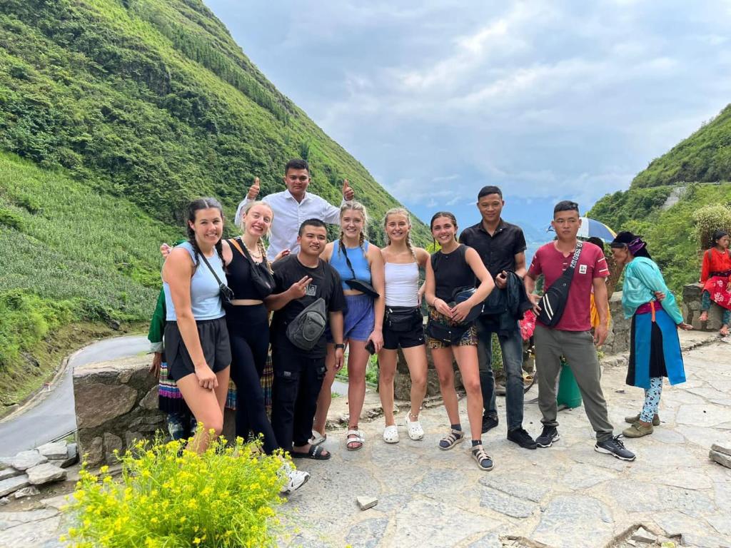 a group of people standing on the side of a mountain at HG Hostel and Motorbikes in Ha Giang