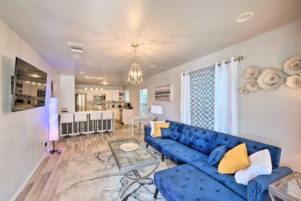 a living room with a blue couch and a table at Family-Friendly Fort Worth Home with Fire Pit! in Fort Worth