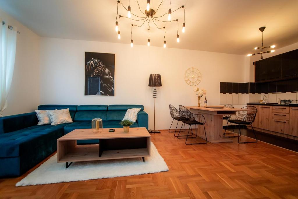 - un salon avec un canapé bleu et une table dans l'établissement Lux stan na dan Pozarevac, à Požarevac