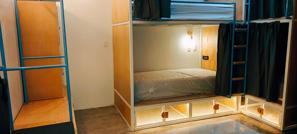 a room with two bunk beds and a bed at Azul Cielo Hostel in Oaxaca City