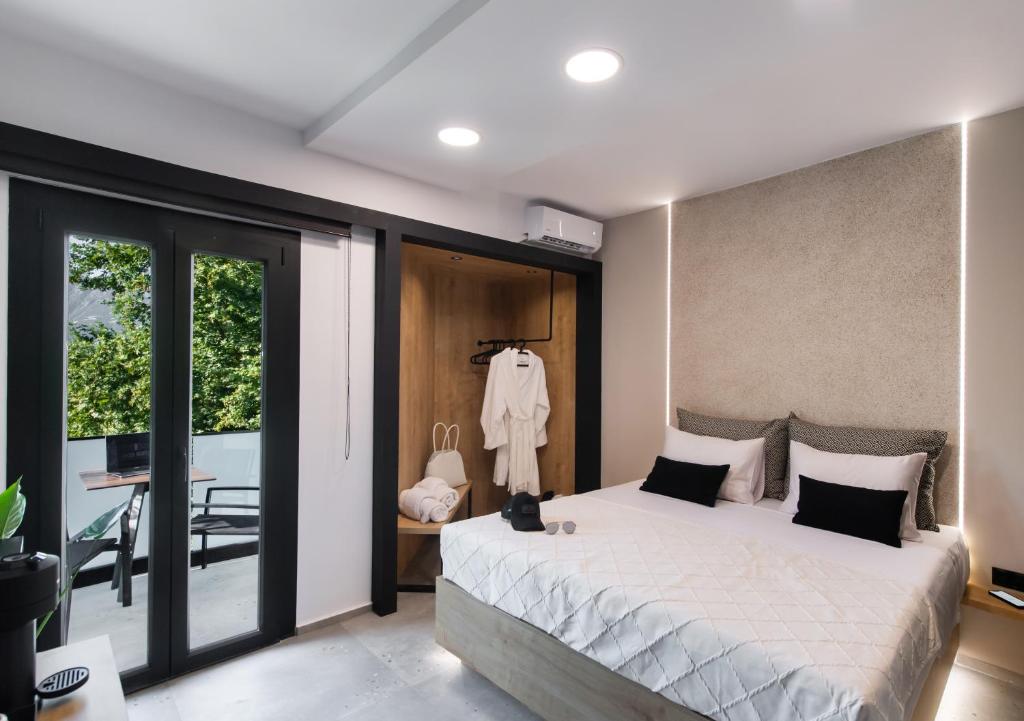 Postel nebo postele na pokoji v ubytování COCO SUITES