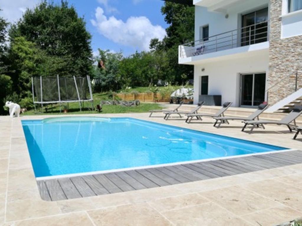 a swimming pool in front of a house at Appartement Urt, 3 pièces, 8 personnes - FR-1-239-795 in Urt