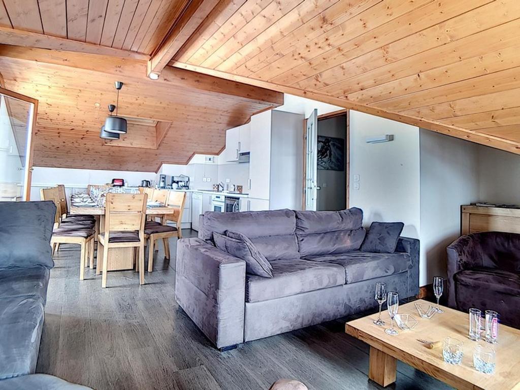 a living room with a couch and a table at Appartement Les Menuires, 6 pièces, 12 personnes - FR-1-344-775 in Levassaix