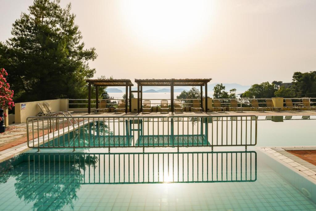 a swimming pool with a table and chairs at Kanapitsa Mare Hotel in Kanapitsa