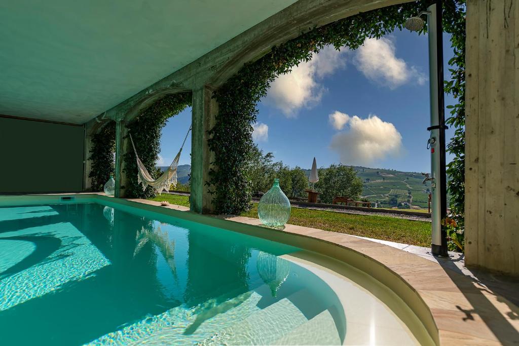 a swimming pool in a house with a view at Il Sassoscritto Bed and Breakfast in Montecalvo Versiggia