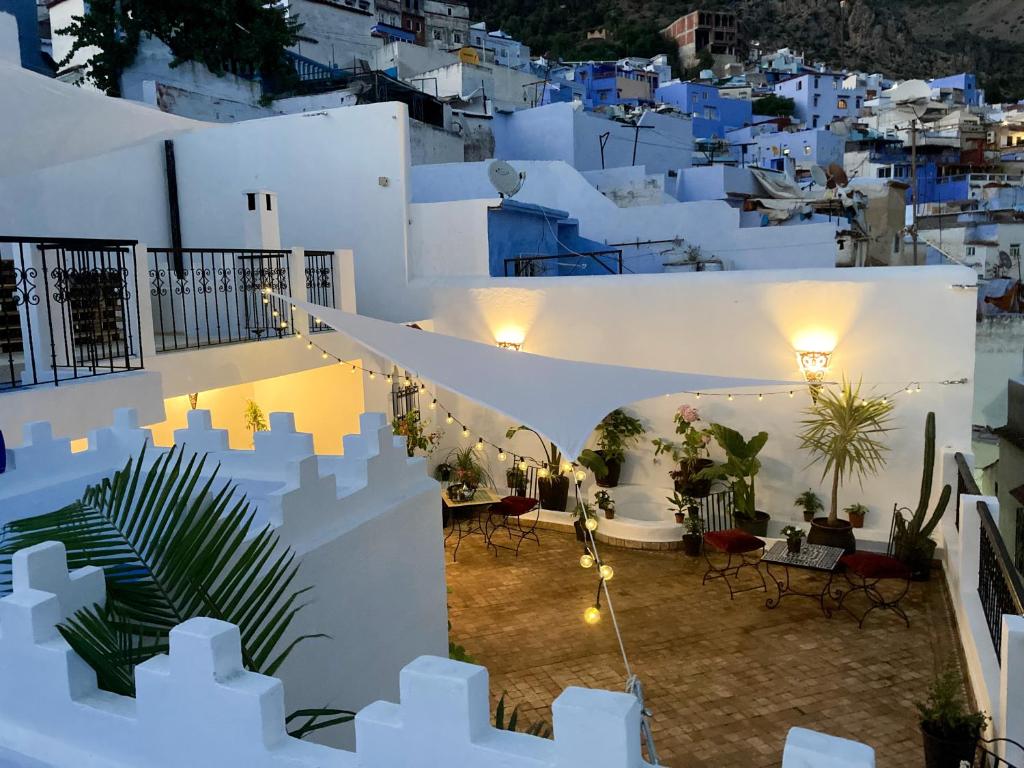 a view of a white building with tables and chairs at Dar Hannan in Chefchaouene