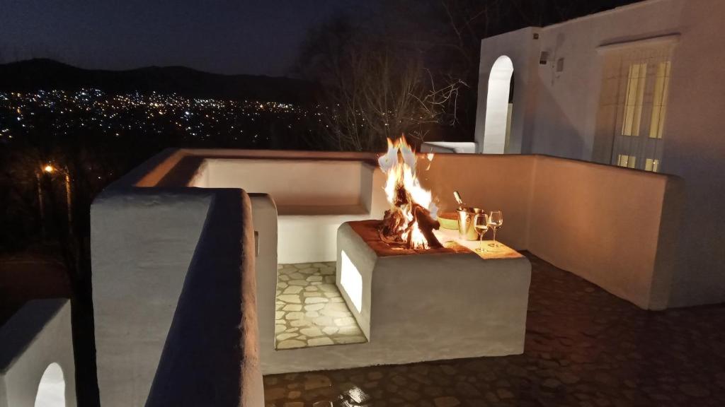 a fire pit on the side of a balcony at night at I Víla in Villa Carlos Paz