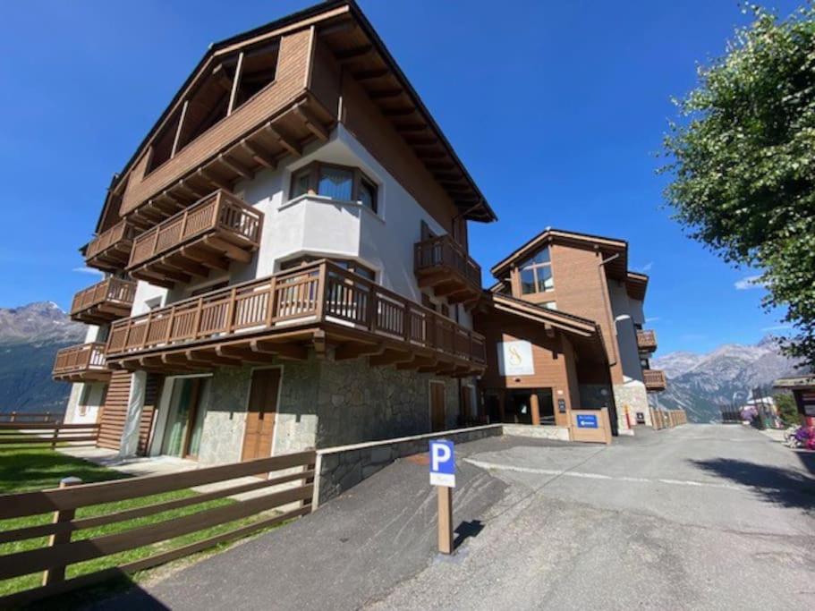 a building with balconies on the side of it at Appartamento trilocale luxory,sulle piste da sci in Bormio