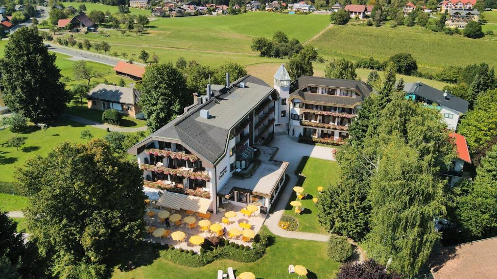 an aerial view of a building with a resort at Hotel Schönruh in Drobollach am Faakersee