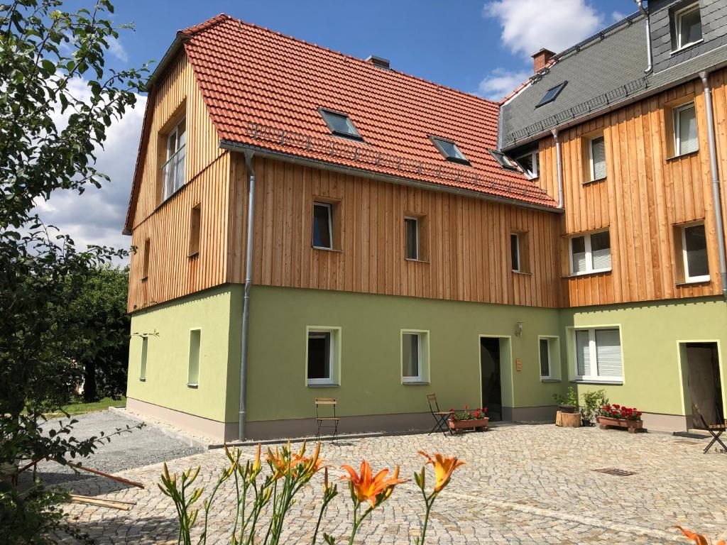 a large building with a red roof at Schöna Urlaub in Schöna